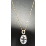 DIAMOND AND GEM SET PENDANT the oval cut gemstone (possibly topaz) below smaller diamonds, in nine