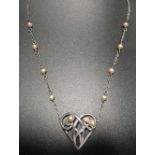 SEED PEARL SET SILVER PENDANT the pierced heart pendant with entwined tendril decoration, on