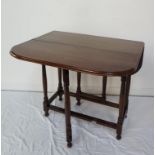 OAK GATELEG DINING TABLE with shaped drop flaps standing on turned supports united by a stretcher,