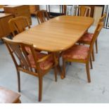 TEAK DINING SUITE the extending dining table with a pull apart top revealing a fold out leaf,