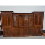 EDWARDIAN MAHOGANY SECTIONAL BOOKCASE with a pair of outer panelled cupboard doors with moulded