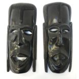 PAIR OF AFRICAN EBONISED TRIBAL MASKS depicting warriors, with cut out eyes and mouth, each 31cm