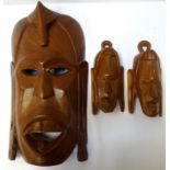 AFRICAN CARVED HARDWOOD TRIBAL MASK depicting a warrior, with cut out eyes and mouth, 36.5cm high,