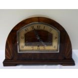 WALNUT AND FIGURED WALNUT MANTLE CLOCK in an arched case, the shaped dial with Arabic numerals and