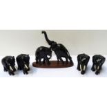 GROUP OF CARVED EBONISED ELEPHANTS with bone tusks and some with bone toe detail (5)