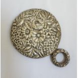 VICTORIAN STERLING SILVER BACKED CIRCULAR DRESSING MIRROR with profuse embossed floral and foliate