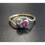 DIAMOND AND RUBY TWO STONE RING on eighteen carat gold shank with twist setting, ring size N-O