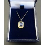 SAPPHIRE AND DIAMOND PENDANT the central sapphire flanked by two small diamonds to the illusion