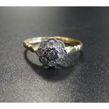 DIAMOND CLUSTER RING the central diamond in eight diamond surround, on eighteen carat gold shank,