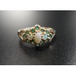 OPAL AND EMERALD CLUSTER RING the three central opals in emerald surround, on nine carat gold shank,