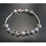 PANDORA MOMENTS SILVER CHARM BRACELET with rose clasp, ten Pandora vintage letter ball charms (A, E,