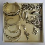 SELECTION OF SILVER JEWELLERY including five bangles of various designs, a mother of pearl set ring,