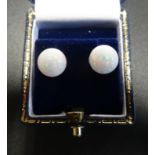 PAIR OF OPAL STUD EARRINGS each formed with a spherical opal, on nine carat gold mounts