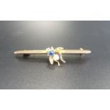NINE CARAT GOLD BAR BROOCH with a sapphire and seed pearl set fly to the centre