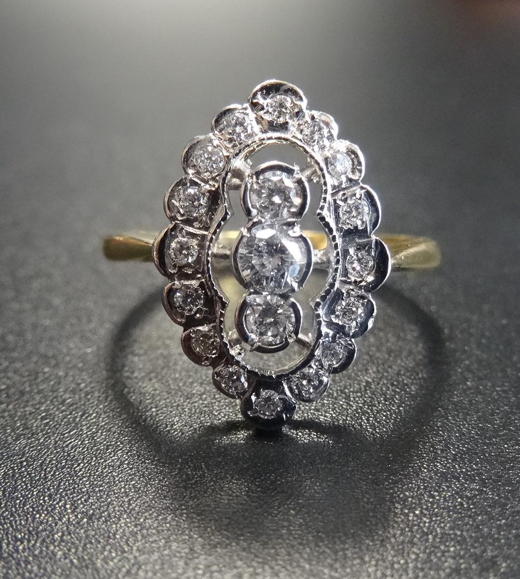 ATTRACTIVE DIAMOND CLUSTER RING the three central vertically set diamonds in further sixteen diamond