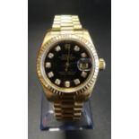 LADY'S EIGHTEEN CARAT GOLD CASED ROLEX OYSTER PERPETUAL DATEJUST WRISTWATCH the black dial set