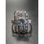 ART DECO STYLE BLUE TOPAZ AND DIAMOND PLAQUE RING the central round cut blue topaz in multi