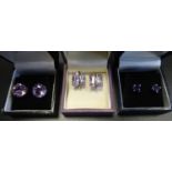 THREE PAIRS OF SILVER EARRINGS comprising two pairs of round cut Amethyst stud earrings of graduated