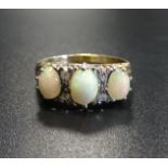 OPAL AND DIAMOND RING the three oval cabochon opals separated by small diamonds, on nine carat