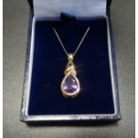 AMETHYST DROP PENDANT in nine carat gold setting with twist decoration, on nine carat gold chain