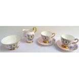 TUSCAN PART TEA SERVICE with a lilac ground and floral motifs with gilt highlights, comprising tea