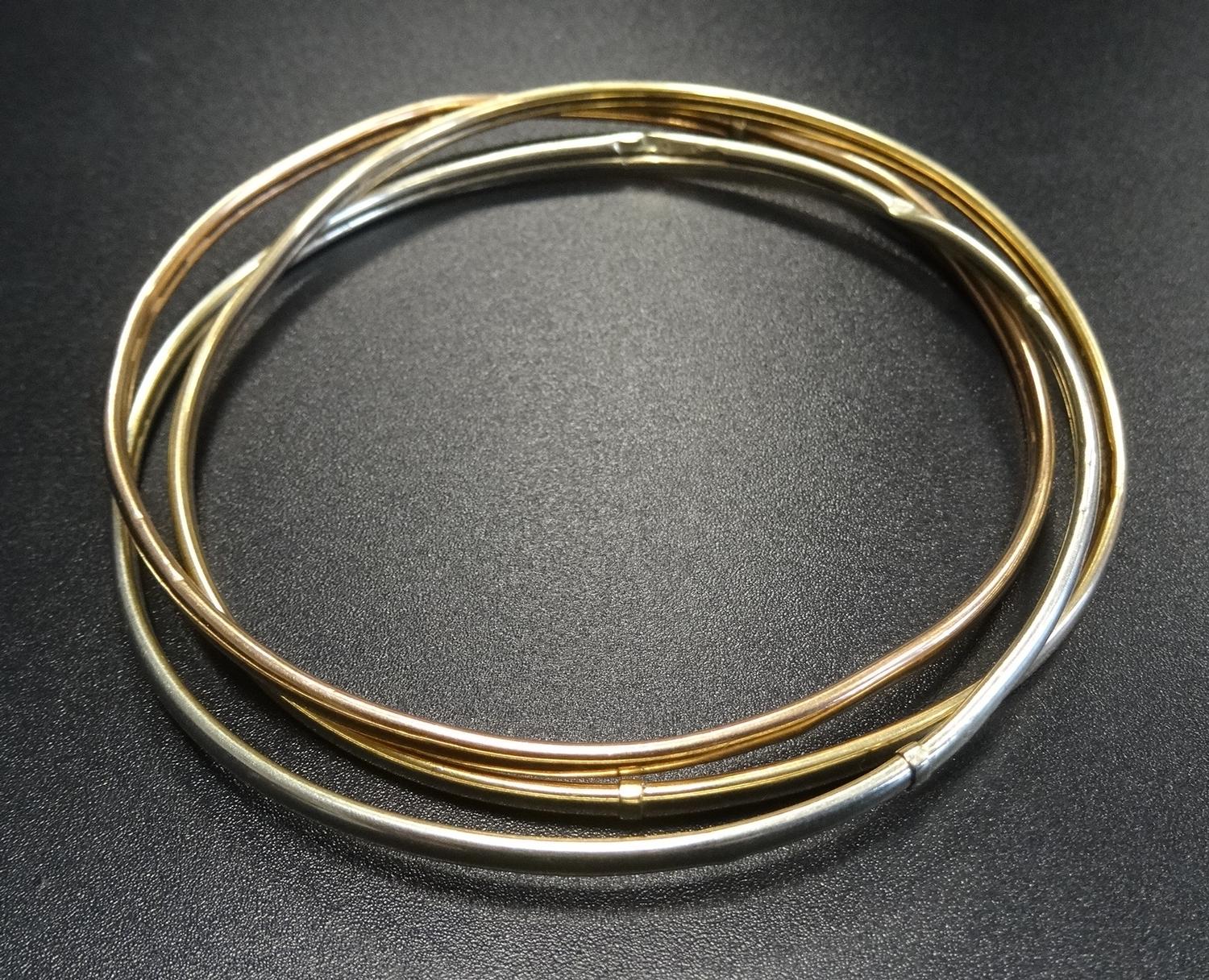 NINE CARAT GOLD RUSSIAN WEDDING RING STYLE TRIPLE BANGLE comprising white, yellow and rose gold