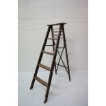 'A' FRAME WOODEN STEPLADDER with four shaped steps and a fold out slatted shelf