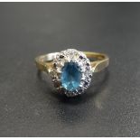 BLUE TOPAZ AND DIAMOND CLUSTER RING the central oval cut blue topaz with small diamonds to the