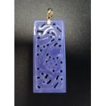 CHINESE CARVED PURPLE JADE PENDANT with pierced and floral decoration, on fourteen carat gold mount,