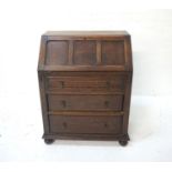OAK WRITING BUREAU early 20th century, the top opening to reveal pigeon holes and drawer, above