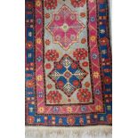 KILIM RUNNER with a central pale blue panel decorated with seven blue and pink stars, encased in a