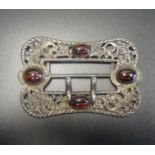 LATE VICTORIAN BELT BUCKLE with cabochon set stones to the decorative pierced and scrolled buckle,