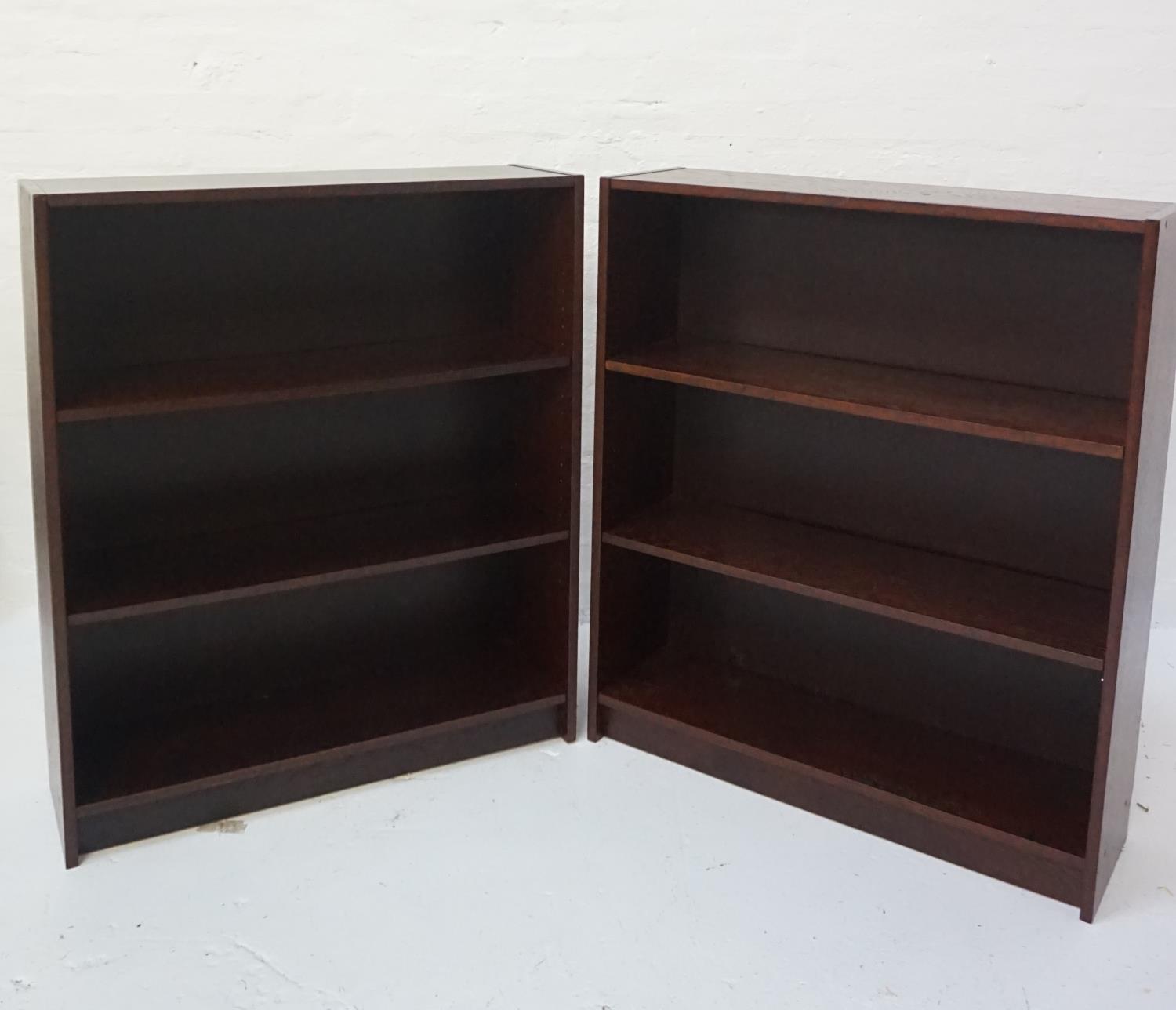 PAIR OF OAK BOOKCASES each with two adjustable shelves, standing on a plinth base, 106cm x 90cm