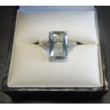 AQUAMARINE AND DIAMOND DRESS RING the central radiant cut aquamarine approximately 3.2cts, flanked