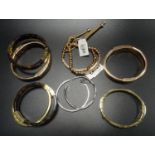 EIGHT MICHAEL KORS BRACELETS comprising two pave crystal set yellow gold tone bangles, two logo