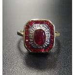 ART DECO STYLE RUBY AND DIAMOND RING the central oval cut ruby in diamond and ruby surround, on nine