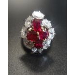 OUTSTANDING RUBY AND DIAMOND CLUSTER RING the central ruby cluster formed with four oval cut