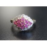 RUBY AND DIAMOND CLUSTER RING the central lozenge shaped ruby cluster in textured surround set