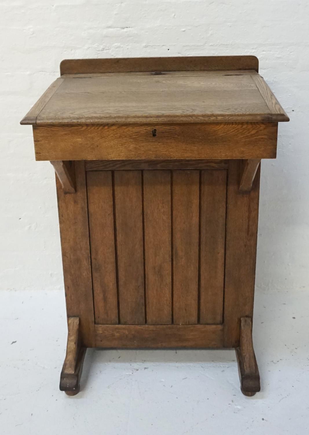 OAK CLERKS DESK the raised back above a pen trough with a central brass inkwell marked 'The Bennet