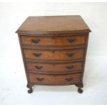 BURR WALNUT BOW FRONT CHEST of four drawers, raised on short cabriole legs, 73.5cm high x 60cm wide.