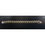 NINE CARAT GOLD CURB LINK BRACELET with safety catches, 20.2cm long and approximately 35.1 grams