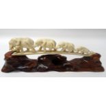 CARVED IVORY BRIDGE OF ELEPHANTS comprising four graduated elephants in procession, 22.5cm long,