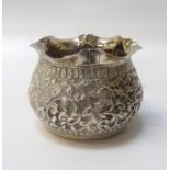 EASTERN SILVER BOWL with frilly rim, the body decorated with floral/foliate scrolls, 5.8cm high