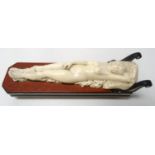 19th CENTURY CONTINENTAL CARVED IVORY RECLINING NUDE FEMALE reclining on a day bed, her head on a