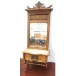 EDWARDIAN OAK TOILET MIRROR with a carved and shaped moulded top above an oblong bevelled plate with