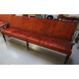 LARGE OAK FRAME BENCH early 20th century, with a padded back and seat, covered in a terracotta