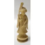 CHINESE CARVED IVORY FIGURE OF A LADY in traditional dress, holding a fan and flowers, 14.9cm high