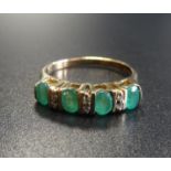 EMERALD AND DIAMOND RING the four oval cut emeralds separated by small diamonds, on nine carat