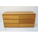 MODERN LIGHT OAK CHEST with an arrangement of six drawers with recessed lip handles, standing on a