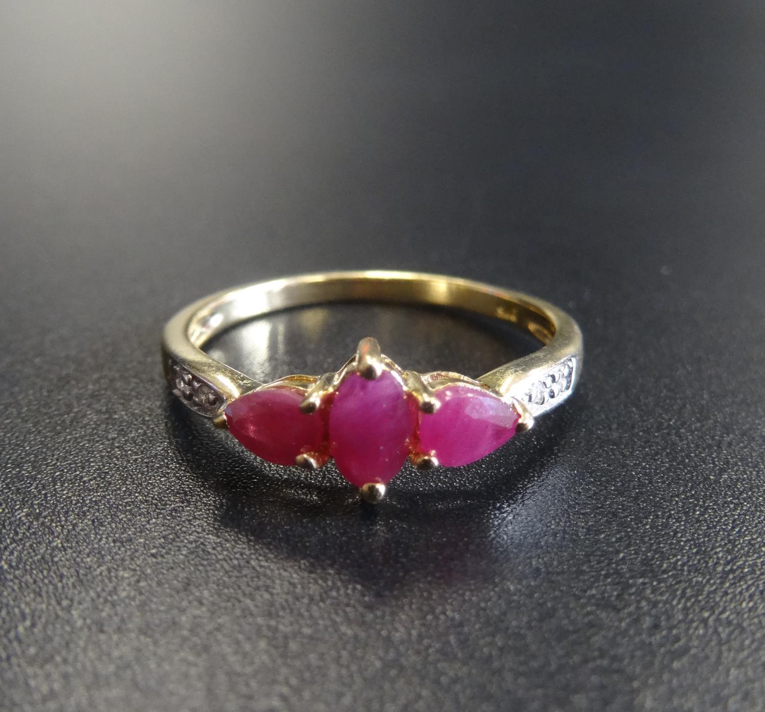 RUBY AND DIAMOND RING the central marquise cut ruby flanked by pear cut rubies and small diamonds,